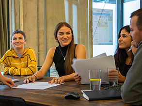 Amigo employees in a meeting room